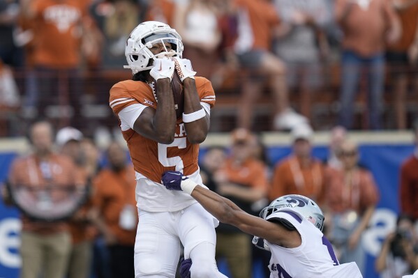 FILE - Texas wide receiver Adonai Mitchell (5) makes a touchdown catch over Kansas State cornerback Jacob Parrish (10) during the first half of an NCAA college football game in Austin, Texas, Saturday, Nov. 4, 2023. Mitchell was selected as the Big 12 newcomer of the year. (AP Photo/Eric Gay, File)