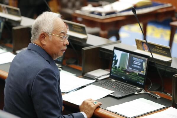 FILE - Malaysia's former Prime Minister Najib Razak attend the parliament session at parliament house in Kuala Lumpur, Malaysia, Monday, Oct. 15, 2018. A surprising disclosure in Parliament that former Malaysia Prime Minister Najib Razak may be gifted a house and piece of land estimated to be worth 100 million ringgit ($24 million) despite his conviction for graft has sparked opposition anger. (AP Photo/Vincent Thian, File)