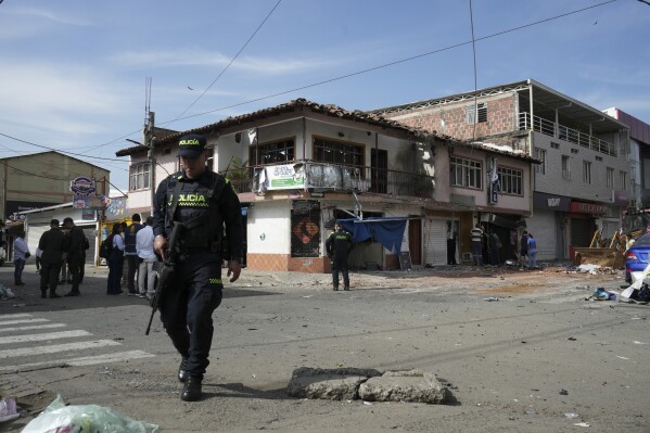 Police patrol the area after a motorcycle bomb exploded at a hotel in which some police officers would be staying in Jamundi, Colombia, Monday, May 20, 2024. According to authorities, two police officers were injured. (AP Photo/Juan B Diaz)