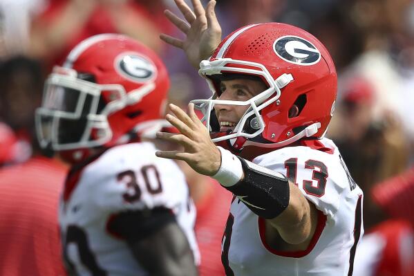 Georgia quarterback Stetson Bennett celebrates his touchdown pass to tight end Brock Bowers that went for 70-plus yards during the third quarter of a NCAA college football game against South Carolina in Columbia, S.C., Saturday, Sept. 17, 2022. (Curtis Compton/Atlanta Journal-Constitution via AP)