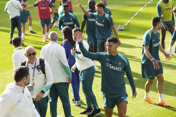 Portugal's Cristiano Ronaldo applauds fans at the end of a training session in Gutersloh, Germany, Friday, June 14, 2024. Portugal will play against Czech Republic during their Group F soccer match at the Euro 2024 soccer tournament on June 18. (AP Photo/Hassan Ammar)