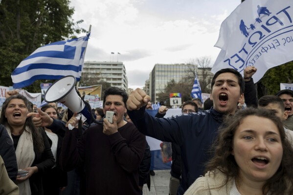 Protesters shout slogans during a rally against same-sex marriage, in central Syntagma Square, Athens, Greece, Sunday, February 11, 2024. More than 1,500 protesters gathered in central Athens to protest oppose legislation that would legalize same-sex marriage in Greece.  The bill is expected to be voted on in Parliament within a few days.  (AP Photo/Yorgos Karahalis)