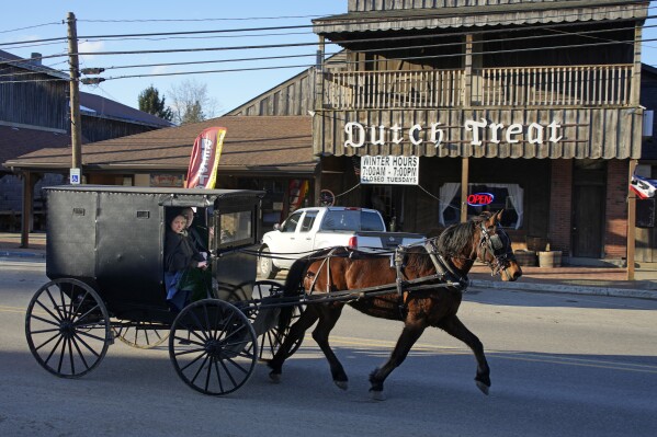 An Amish carriage passes the Dutch Treat restaurant in Spartansburg, Pa., on Thursday, Feb. 29, 2024. The body of a pregnant 23-year-old Amish woman was discovered on Monday in her home a few miles outside of Spartansburg. Pennsylvania State Police are appealing for tips from the public to help solve the crime, a state police spokeswoman said Wednesday. (AP Photo/Gene J. Puskar)