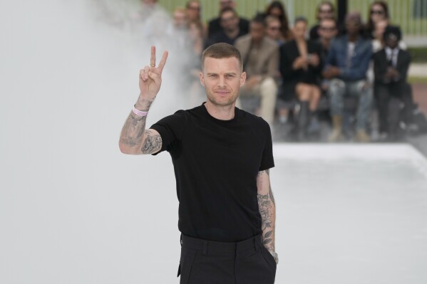 FILE - Designer Matthew Williams accepts applause after the Givenchy men's Spring Summer 2023 collection presented in Paris, France, Wednesday, June 22, 2022. Givenchy, the renowned Parisian heritage house owned by LVMH, announced Friday Dec.1, 2023 that Matthew M. Williams will step down as its creative director. Williams, who has been at the helm since June 2020, is set to depart from the role at the beginning of next year (AP Photo/Francois Mori, File)