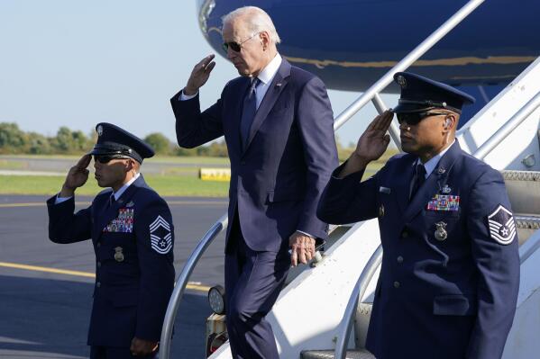 President Joe Biden returns a salute as he exits Air Force One at Philadelphia International Airport in Philadelphia, Friday, Oct. 7, 2022. (AP Photo/Manuel Balce Ceneta)