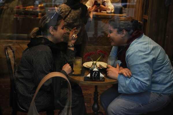 Women enjoy their time in a café in northern Tehran, Iran, Monday, June 2, 2025. (AP Photo/Vahid Salemi)