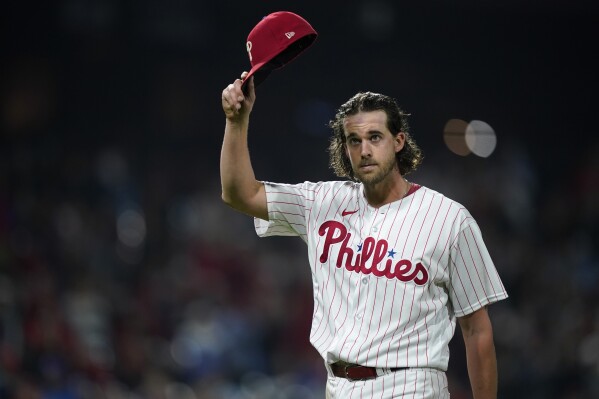 Philadelphia Phillies pitcher Aaron Nola acknowledges the crowd after being pulled during the seventh inning of a baseball game against the Pittsburgh Pirates, Tuesday, Sept. 26, 2023, in Philadelphia. (AP Photo/Matt Slocum)