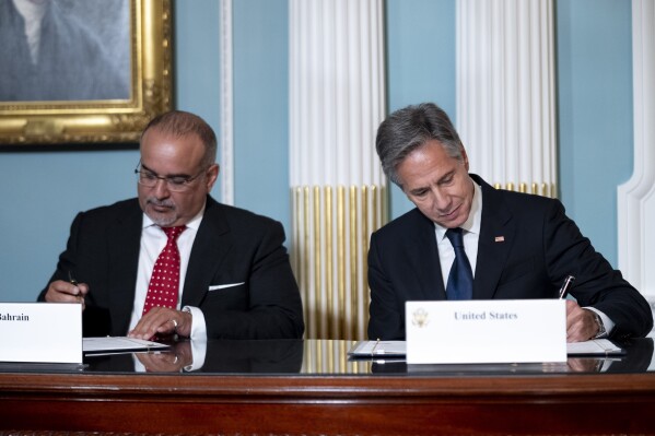 Bahraini Crown Prince Al Khalifa, left, and Secretary of State Antony Blinken, right, sign a Comprehensive Security Integration and Prosperity Agreement during a signing ceremony at the State Department, Wednesday, Sept. 13, 2023, in Washington. (AP Photo/Andrew Harnik)