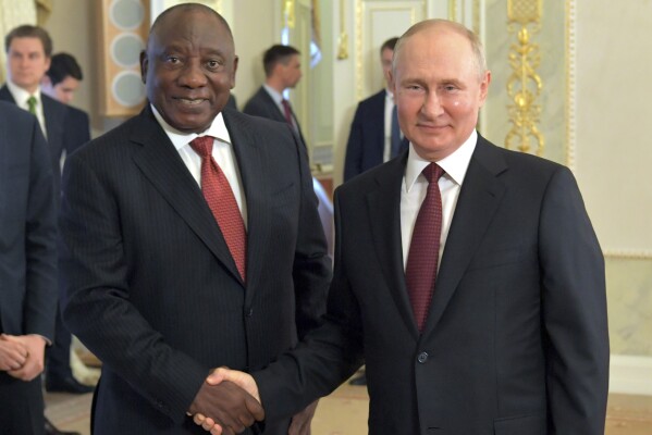 In this handout photo provided by Photo host Agency RIA Novosti, Russian President Vladimir Putin, right, and South African President Cyril Ramaphosa pose for a photo during a meeting with a delegation of African leaders and senior officials in St. Petersburg, Russia, Saturday, June 17, 2023. Seven African leaders — presidents of Comoros, Senegal, South Africa and Zambia, as well as Egypt's prime minister and top envoys from the Republic of Congo and Uganda — traveled to Russia on Saturday a day after visiting Ukraine on a mission to try to help end the hostilities. (Evgeny Biyatov/Photo host Agency RIA Novosti via AP)