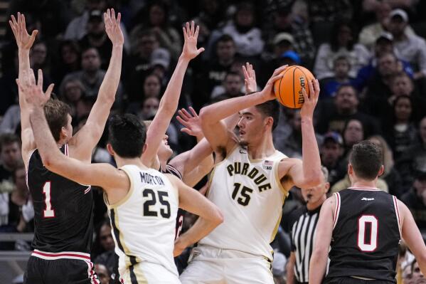 Purdue center Zach Edey (15) is surrounded by Davidson players in the second half of an NCAA college basketball game in Indianapolis, Saturday, Dec. 17, 2022. Purdue defeated Davidson 69-61. (AP Photo/Michael Conroy)
