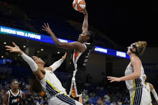 Dallas Wings' Kayla Thornton, front left, and Marina Mabrey, right, defend as Phoenix Mercury center Tina Charles (31) shoots in the second half of a WNBA basketball game, Friday, June 17, 2022, in Arlington, Texas. (AP Photo/Tony Gutierrez)