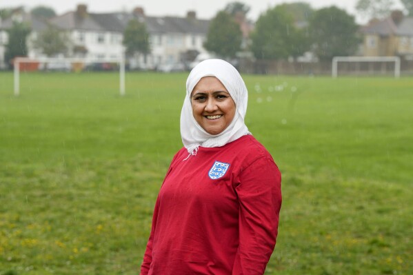 Huda Jawad poses for photos in a park near her home, in London, Friday, Aug. 18, 2023. Jawad is a member of a fan group known as the Three Hijabis for their traditional Muslim headscarves, a group that campaigns against discrimination in football. (AP Photo/Frank Augstein)