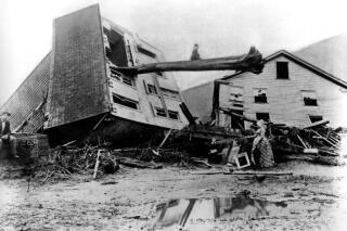 Survivors stand by homes destroyed when the South Fork Dam collapsed May 31 in Johnstown, Pa., in 1889. (AP Photo)