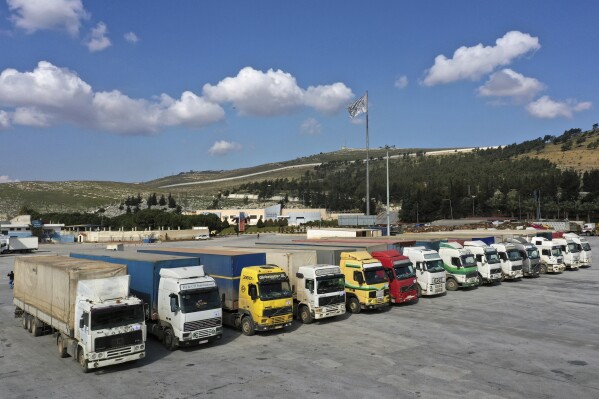 FILE - Trucks loaded with United Nations humanitarian aid for Syria following a devastating earthquake are parked at Bab al-Hawa border crossing with Turkey, in Syria's Idlib province, on Feb. 10, 2023. On Tuesday, July 11, 2023, the U.N. Security Council failed to renew the Bab al-Hawa border crossing into opposition-held northwestern Syria from Turkey. (AP Photo/Ghaith Alsayed, File)