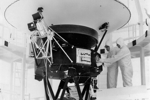 FILE - In this Aug. 4, 1977, photo provided by NASA, the "Sounds of Earth" record is mounted on the Voyager 2 spacecraft in the Safe-1 Building at the Kennedy Space Center, Fla. On Wednesday, Aug. 2, 2023, NASA's Deep Space Network sent a command to correct a problem with its antenna. It took more than 18 hours for the signal to reach Voyager 2 _ more than 12 billion miles away _ and another 18 hours to hear back. On Friday, Aug. 4, the spacecraft started returning data again. (AP Photo/NASA, File)