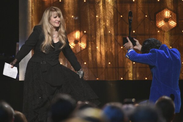 FILE - Harry Styles, right, presents a trophy to Stevie Nicks at the Rock & Roll Hall of Fame induction ceremony in New York on March 29, 2019. Nicks has become close friends when the former One Direction member since he invited her to perform at one of his concerts in 2017.
Since then, they’re performed several times together and Styles even previewed his latest album, “Fine Line,” for her and some of her friends before it was released in December. (Photo by Evan Agostini/Invision/AP, File)