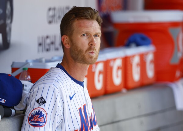 New York Mets relief pitcher Michael Tonkin (51) sits in the dugout during the 11th inning in the first baseball game of a doubleheader, against the Detroit Tigers, Thursday, April 4, 2024, in New York. (AP Photo/Noah K. Murray)