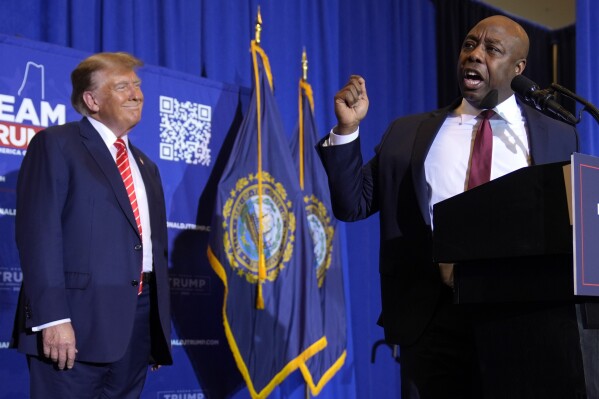 Sen. Tim Scott, R-S.C., speaks as Republican presidential candidate former President Donald Trump listens at a campaign event in Concord, N.H., Friday, Jan. 19, 2024. (AP Photo/Matt Rourke)