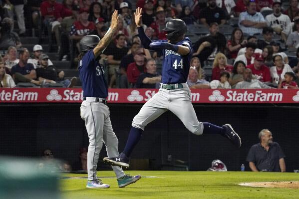 Seattle Mariners' Julio Rodriguez, right, celebrates with J.P. Crawford after they scored on a single by Kevin Padlo during the sixth inning of a baseball game Saturday, June 25, 2022, in Anaheim, Calif. (AP Photo/Mark J. Terrill)