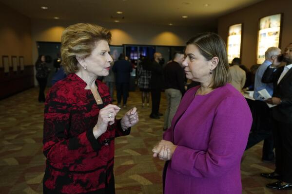 Sen. Debbie Stabenow, D-Mich., left, talks with Rep. Elissa Slotkin, Monday, Jan. 16, 2023, in Lansing, Mich. Rep. Slotkin is taking steps toward seeking the U.S. Senate seat held by Stabenow who is retiring. Slotkin has quickly shifted from fighting for her political life in the nation's third most-expensive U.S. House race last year to "at the very top" of the Michigan Democrats readying for a 2024 Senate campaign. (AP Photo/Carlos Osorio)