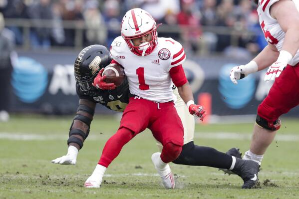 FILE - Nebraska wide receiver Wan'Dale Robinson (1) is chased down by Purdue defensive tackle Anthony Watts (8) during the first half of an NCAA college football game in West Lafayette, Ind., in this Saturday, Nov. 2, 2019, file photo. The NCAA made it official Thursday, April 15, 2021, announcing the Division I Council had voted to approve a proposal that would permit all college athletes to transfer one time as an undergraduate without having to sit out a season. Among the notable transferring football players who will now be eligible next season at their new schools are Wan'Dale Robinson, who switched from Nebraska to Kentucky. (AP Photo/Michael Conroy, File)