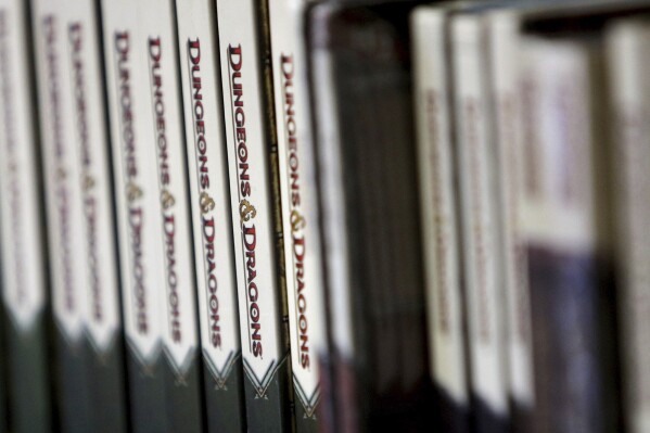 FILE - Dungeons & Dragons books sit on display at Cape Fear Games in Wilmington, N.C., on Aug. 8, 2014. The Dungeons & Dragons role-playing game franchise said Saturday, Aug. 5, 2023, that it won't allow artists to use artificial intelligence technology to draw its cast of sorcerers, druids and other characters and scenery. (Jason A. Frizzelle/The Star-News via AP, File)