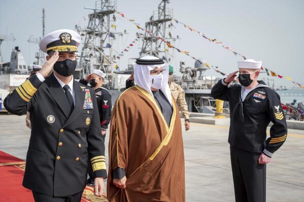 In this Jan. 31, 2022, photo provided by U.S. Central Command, Bahrain's Crown Prince and Prime Minister, Salman bin Hamad Al Khalifa and Vice Adm. Brad Cooper, commander of U.S. Naval Forces Central Command, arrive at the pier at Naval Support Activity (NSA) Bahrain. (Spc. 1st Class Mark Thomas Mahmod/U.S. Central Command via AP)