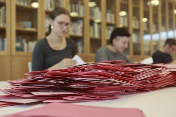 A view of a pile of ballot papers during the counting of the postal vote at the Bürgerhaus Nordhausen polling station, Germany, Sunday, Sept. 24, 2023. The German city of Nordhausen is best known as the location of the former Nazi concentration camp Mittelbau-Dora. On Sunday, a mayoral election could again put the focus on the municipality of 42,000 people if a far-right candidate wins the vote.Joerg Prophet, a candidate from the populist far-right Alternative for Germany party, or AfD, is the frontrunner in Sunday’s mayoral runoff vote. (Matthias Bein/dpa via AP)