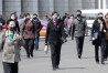 FILE - Pedestrians wear face masks to help prevent the spread of the new coronavirus in Pyongyang, North Korea, on April 1, 2020. North Korea is putting surveillance cameras in schools and workplaces, and collecting fingerprints, photographs and other biometric information from its citizens in a technology-driven push to monitor its population even more closely, a report said Tuesday, April 16, 2024. (AP Photo/Cha Song Ho, File)
