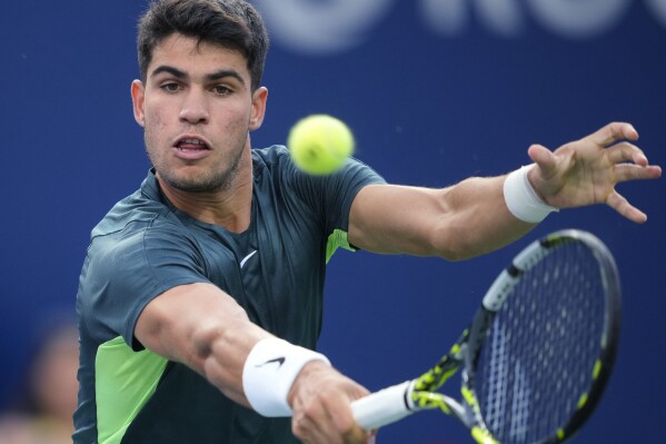 Spain's Carlos Alcaraz returns a shot to United States' Ben Shelton during the National Bank Open men’s tennis tournament Wednesday, Aug. 9, 2023, in Toronto. (Mark Blinch/The Canadian Press via AP)