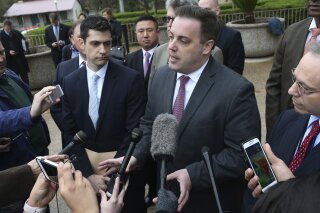 In this Feb. 22, 2018 photo, Joe Blackwell addresses the media outside the U.S. Federal Courthouse in San Antonio, Texas.   Criminal allegations from Texas Attorney General Ken Paxton top deputies have set him up to square off against what may be his most formidable opponent yet: A federal prosecutor with a team of seasoned FBI agents and a track record of getting corrupt public officials sent to prison. Overseeing the probe is Blackwell, according to a person familiar with the investigation who insisted on anonymity because the investigation is ongoing.  (Jerry Lara/The San Antonio Express-News via AP)