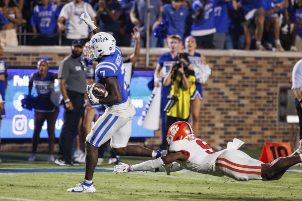 Duke's Jordan Waters (7) scores a touchdown ahead of Clemson's R.J. Mickens (9) to seal a victory late in the second half of an NCAA college football game in Durham, N.C., Monday, Sept. 4, 2023. (AP Photo/Ben McKeown)