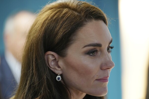 FILE - Britain's Kate, Princess of Wales, listens to staff as she and Prince William visit the Open Door Charity, a charity focused on supporting young adults across Merseyside with their mental health, using culture and creativity as the catalyst for change in Birkenhead, England, Jan. 12, 2023. (AP Photo/Jon Super, Pool, File)