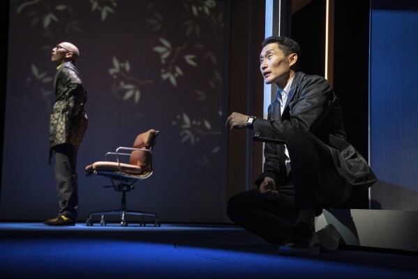 This image released by Polk & Co. shows Francis Jue, left, and Daniel Dae Kim during a performance of "Yellow Face on Broadway," a play by David Henry Hwang, in New York. (Joan Marcus/Polk & Co. via AP)