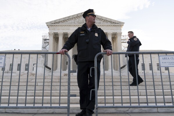 Police put a fence outside of the U.S. Supreme Court, Thursday, Feb. 8, 2024, in Washington. (AP Photo/Jose Luis Magana)