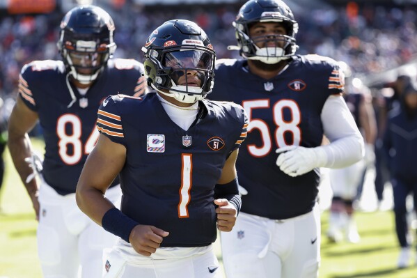 FILE - Chicago Bears quarterback Justin Fields (1) jogs off the field after the first half of the team's NFL football game against the Minnesota Vikings, Oct. 15, 2023, in Chicago. Fields practiced Friday, Nov. 3, for the first time since dislocating his thumb in a game last month and moved closer to returning to the field on game day. Fields has been labeled doubtful for Sunday's game with New Orleans. He has been taking part in meetings and is aware of the game plan, even if the limited practice was his first since being injured. (AP Photo/Kamil Krzaczynski, File)