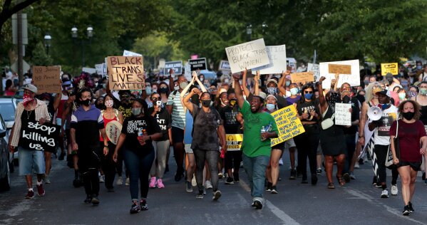 Hundreds of protesters march down Waterman Boulevard headed to St. Louis Mayor Lyda Krewson's home on Sunday, June 28, 2020, in St. Louis. The protesters demanded Krewson's resignation after she read the names and addresses of several residents who supported defunding the police department during an online briefing.    (Robert Cohen/St. Louis Post-Dispatch via AP)