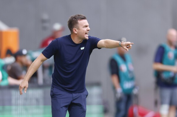 Coach Enrico Maassen of FC Augsburg gives instructions to his team during the German Bundesliga soccer match between FC Augsburg and SV Darmstadt 98 at the WWK Arena in Augsburg, Germany, Saturday, Oct. 7, 2023. (Daniel Löb/dpa via AP)