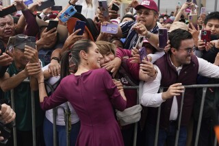 Presidential candidate Claudia Sheinbaum greets supporters upon her arrival to her opening campaign rally at the Zocalo in Mexico City, Friday, March 1, 2024. General Elections are set for June 2. (AP Photo/Aurea Del Rosario)