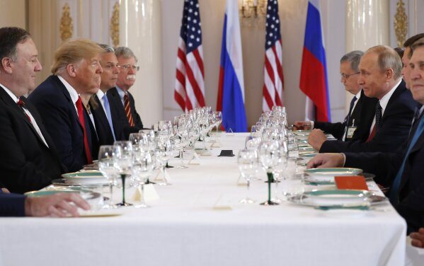 
              U.S. President Donald Trump, second from left, and Russian President Vladimir Putin, second from right, wait for the beginning of a working lunch at the Presidential Palace in Helsinki, Finland, Monday, July 16, 2018. (AP Photo/Pablo Martinez Monsivais)
            