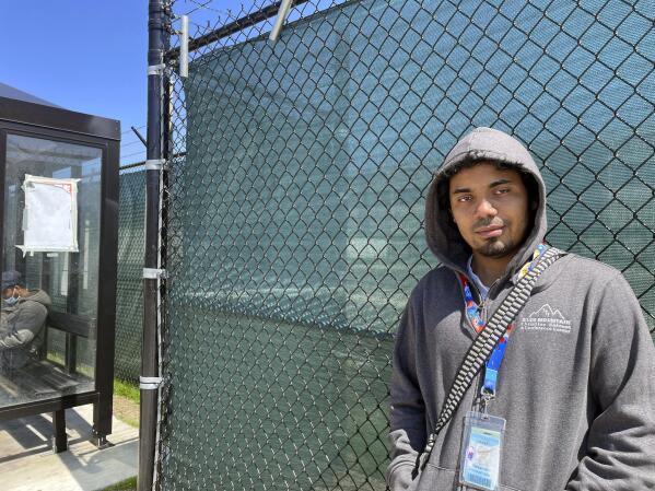 Alexander Campbell, a 25-year-old warehouse worker, stands by Amazon's LDJ5 warehouse in the Staten Island borough of New York on Friday, April 29, 2022.   The National Labor Relations Board will count votes Monday in the second union election among Amazon workers on Staten Island, New York, a rematch for the retailer and the nascent group of worker organizers right on the heels of their historic labor victory.  Campbell voted against the union, saying he read some things online that convinced him his wages might go down if the warehouse unionized.  (AP Photo/Haleluya Hadero)