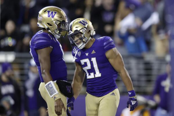 Washington running back Wayne Taulapapa (21) celebrates his touchdown against Oregon State with quarterback Michael Penix Jr. (9) during the first half of an NCAA college football game Friday, Nov. 4, 2022, in Seattle. (AP Photo/John Froschauer)