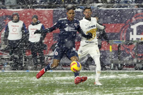 New England Revolution midfielder Brandon Bye (15) and Pumas defender Jeronimo Rodriguez (16) vie for the ball in the snow during the first half of a CONCACAF Champions League soccer match Wednesday, March 9, 2022, in Foxborough, Mass. (AP Photo/Mary Schwalm)