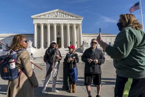 Protesters for and against President Donald Trump debate each other at the Supreme Court in Washington, Friday, Dec. 11, 2020. (AP Photo/J. Scott Applewhite)