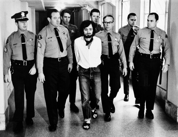 Charles Manson is heavily escorted back to his cell after being found guilty of first degree murder in Los Angeles, Jan. 25, 1971. (AP Photo/Pool)