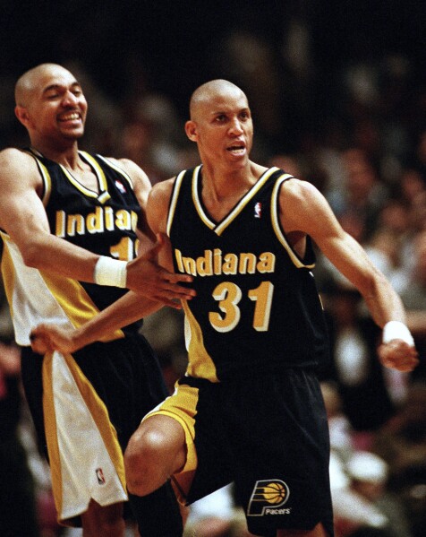 Indiana Pacers guards Reggie Miller (31) and Mark Jackson taunt New York film director and avid Knicks fan Spike Lee, after Miller scored eight points in the last quarter of the game against the Knicks, at New York's Madison Square Garden, May 7, 1995. (AP Photo/Bill Kostroun, File)