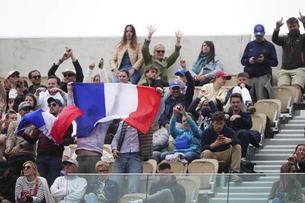 FILE -Fans cheer during the first round match of the French Tennis Open between France's Arthur Fils and Chile's Nicolas Jarry, at the Roland-Garros stadium, in Paris, Monday, May 26, 2025. (AP Photo/Lindsey Wasson, File)