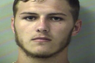 In this Thursday, Aug. 15, 2019, booking photo from the Okaloosa County Sheriff's Office shows Hunter Mills. Authorities say the Florida man used a front-end loader to dump a large bucket full of dirt on a car with his girlfriend was inside. The Okaloosa County Sheriff's Office says Mills was charged with felony criminal mischief. (Okaloosa County Sheriff's Office via AP)