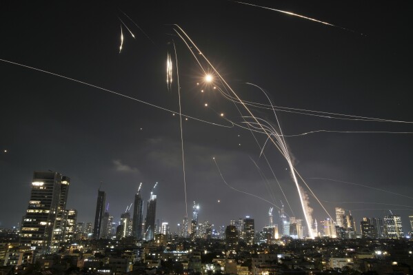 Israeli Iron Dome air defense system fires to intercept missiles over Tel Aviv, Israel, Friday, June 13, 2025. (AP Photo/Leo Correa)