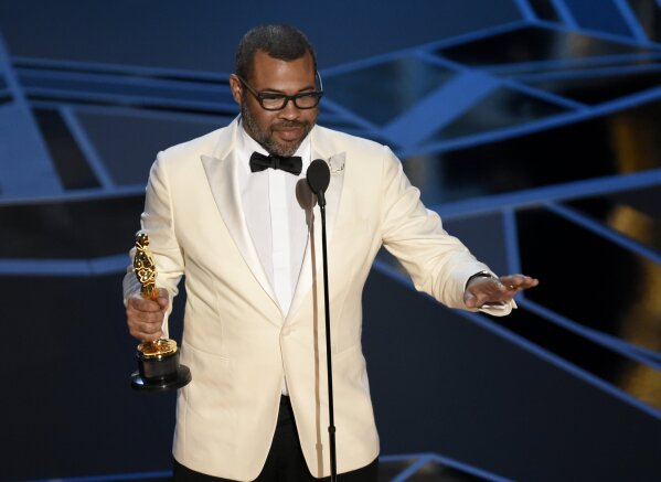 
              Jordan Peele accepts the award for best original screenplay for "Get Out" at the Oscars on Sunday, March 4, 2018, at the Dolby Theatre in Los Angeles. (Photo by Chris Pizzello/Invision/AP)
            